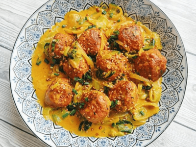 Plato de albondigas con una salsa amarilla